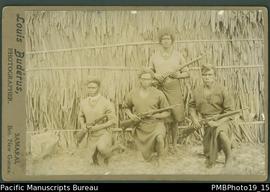 Mounted photograph of four Papua New Guinean armed policemen.