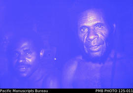 'Lumusa area [village near Kakemale]: two men inside a traditional house'