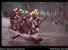 Asmat men on canoe, Asmat