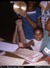 "29. Tralimbuwa, M.C.H. clinic staff nurse, with daughter Agnes - weighing a baby in clinic ...