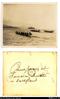 "Canoe racing at Samarai, [ship] in background. Printed by Harringtons."