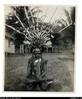 No label. Man in ceremonial head dress called Tubuka in the Motu language and his pectoral orname...