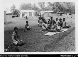 ni-Vanuatu women and children sitting on grass