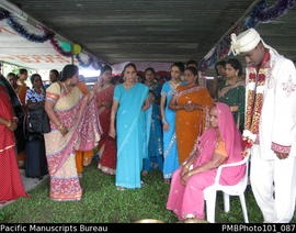 [Suva] Wedding Mahen the groom standing near his seated mother with other female relatives]