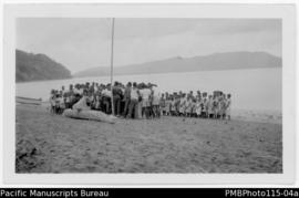 'Young men sing farewell to the happy couple while they sit on a canoe on the beach. Marriage cus...