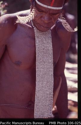 [Dani leader with ‘bib’ necklace of small many cowrie shells worn only by high-status men, usuall...