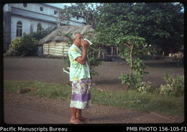 Village mayor sounds conch shell to announce a meeting, Upolu, Samoa