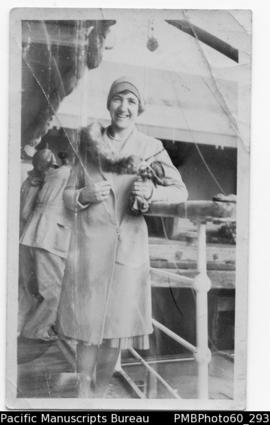 European woman standing on deck of ship