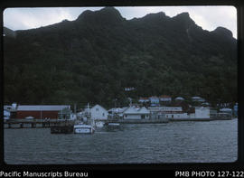 'Closeup of jetty with fishing boat alongside and Morris Hedstrom in background, Levuka, Fiji'