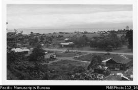 Lae [Morobe District;  roads, truck, buildings one with a large “T” on roof]