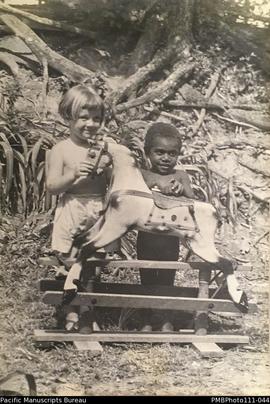 'Playmates', Janet Stallan and young Malekulan child playing, probably at Wintua mission house
