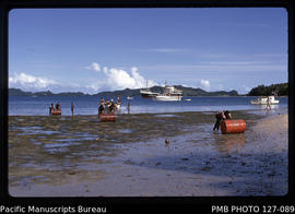 'Discharging oil drums from punts onto dry reef at Lomaloma, Fiji'
