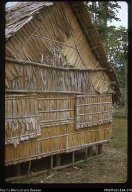 'End view of John Baker's house - showing ivory nut leaf walls, Wagina Island'