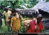 Women on Sepik Highway towards Maprik with loads of cocoa [peanuts] [East Sepik Province]