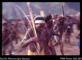 [Lani men from Wunin village whoop it up during a pig feast and mock battle that I (Muller) had o...