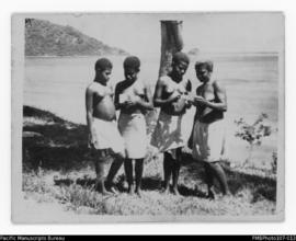 Four women at the shoreline (Lehi on right), Wintua, South West Bay, Malekula, ten stick island i...