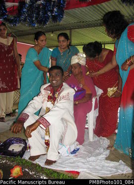 [Suva Wedding Mahen the groom dressed in wedding clothes with his mother (wearing his hat)  and o...