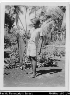 Young man holding a big fish