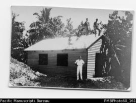 Building workshop with ni-Vanuatu men on roof