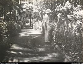 'Benauer. January 1941', man in white suit and hat standing on path