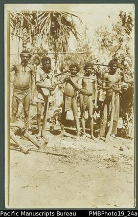 Five men, some holding spears, Northern Territory, Australia.