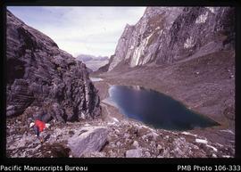 [Trekker and glacier lake near Puncak Jaya; Freeport’s Grasberg mine in background]