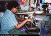 Harrison Bethel sewing hand bags in Womens Craft Market, Port Vila