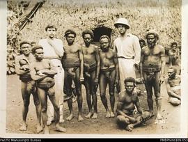 Tom Harrison and Chuck Lewis (in safari hat) with Big Nambas men, probably in Tenmaru, Malekula.