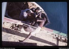 'Lifting bags of gravel into MV Myrtle from dinghy alongside at Kenelo, Rendova Island'