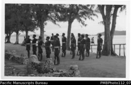 Samarai [Island, Milne Bay District;  Papuan police presenting arms on Samarai]
