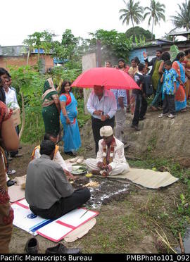 [Suva Wedding  Ceremony outside at the bride's family home - the groom Mahen being sheltered  by ...