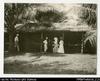 Larger format photograph of two European women and two men standing by horse stables (same women ...