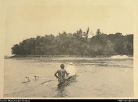 'Taken ashore at Toman', European and ni-Vanuatu men in canoe, Toman island, Malekula