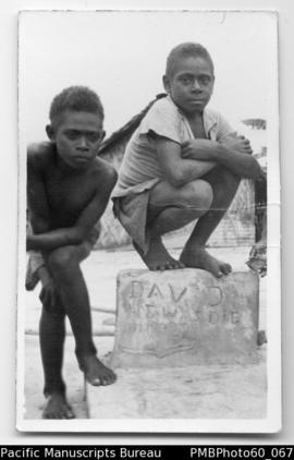 Two young boys by a tombstone, South Malekula