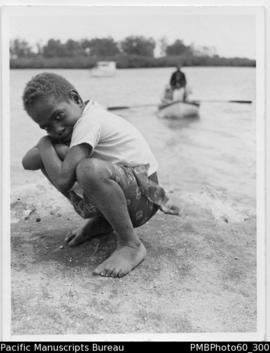Young boy at water edge