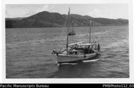 Samarai [Island, Milne Bay District;  approaching Samarai, boat Jessie with people and cargo on d...