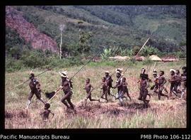 [Warriors running as in a war attack, near Wamena, Baliem Valley, as in previous shots]