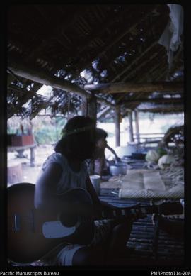 'Gilbertese girl playing the banjo, Wagina Island'