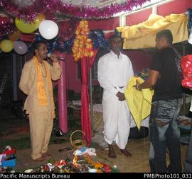 [Suva Wedding]  Mahen the groom in white clothing with priest and guest]