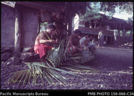 Taulele’a [untitled young men] preparing for a family Sunday meal after church - making baskets f...
