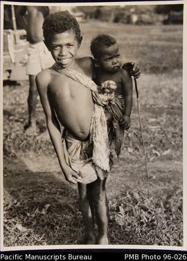 Young boy carrying a baby