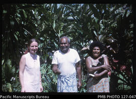 'Liz Baker, Manuele and Asena (caretakers) and cat Doka in garden of 30 Beach Road, Suva, Fiji'