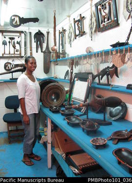 [Suva] [assistant in Fijian artefact shop]