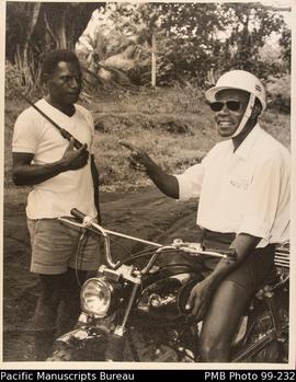 Pastor Silas on his motorbike stops to talk to Elder Gideon in a distant part of his parish.
