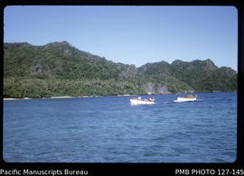 'Punt towing whaleboat along coastline, Fiji'