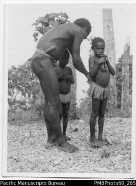 ni-Vanuatu man with two young daughters