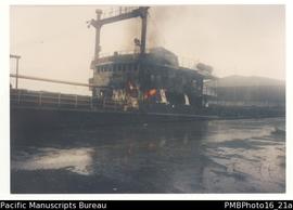 Burning ship Cosmaris at wharf.
