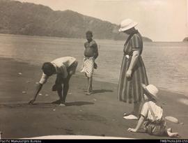 Christina Stallan with two people and one of the Stallan children on the beach, South West Bay, M...