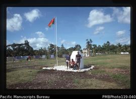 'Memorial plaque and flag, Talua'