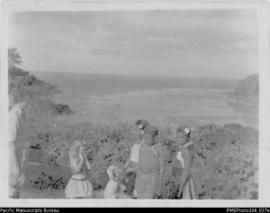 Women and girls with Conrad Stallan, ocean view behind.